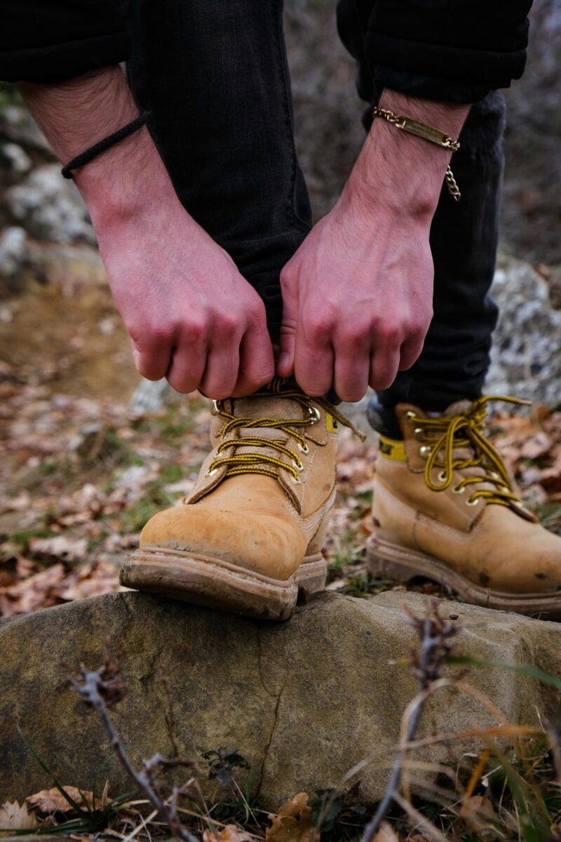Close-up of Man Fixing His Shoe Outside
